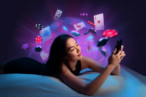 A young woman relaxing with her phone while dynamic casino elements float around her, illustrating the smooth mobile experience offered by the JL520 app.
