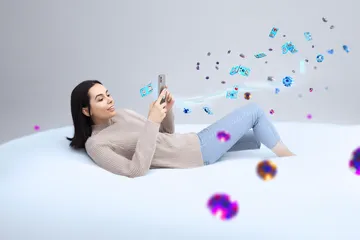 A cheerful woman in traditional clothing using her smartphone during a festive moment, showing how easily the JL520 app fits into everyday life.